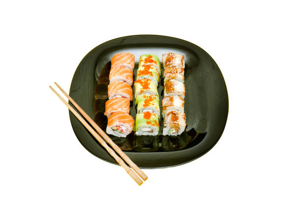 istock Black plate with various rolls.  Food concept. Isolated. White background 940933950