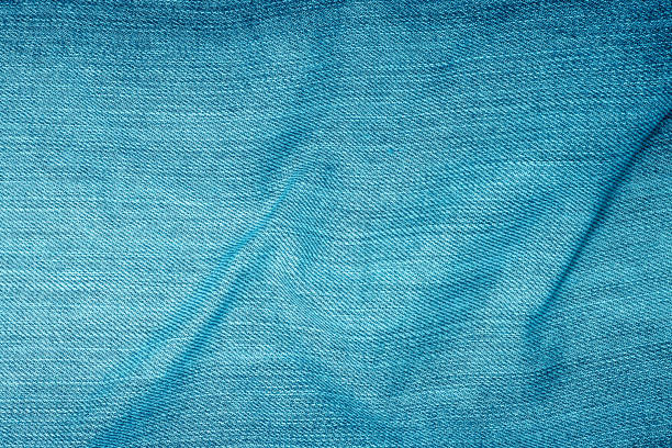 istock Texture of old denim or blue jeans background 940937214