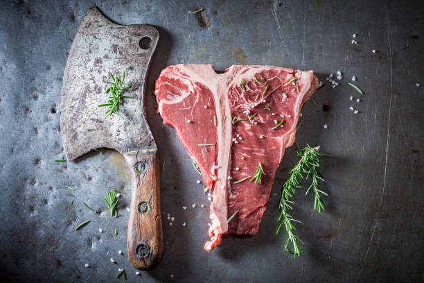 istock Raw and fresh red steak on old metal table 940937436