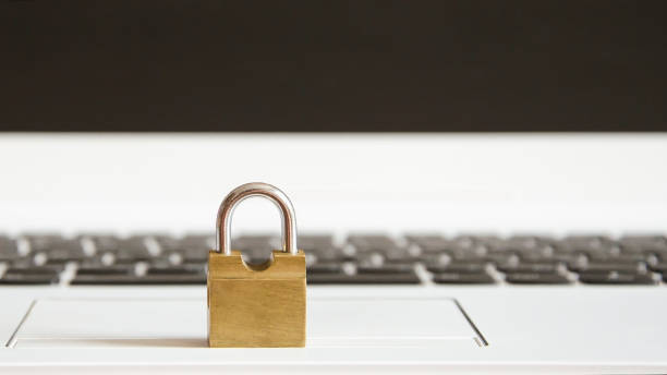 istock Yellow castle stands on a white laptop 940937614