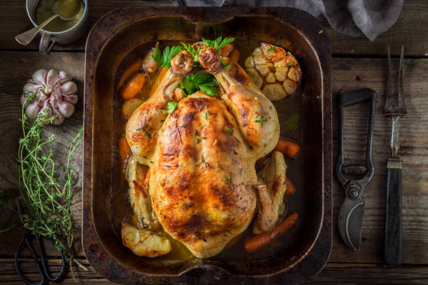 istock Golden grilled chicken with herbs and vegetables 940937650