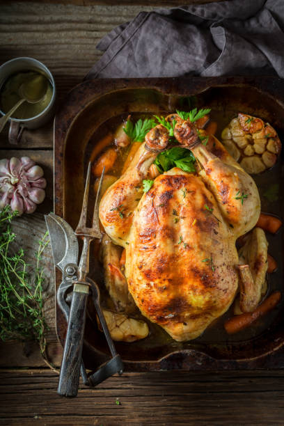 istock Tasty roasted chicken with hebrs and vegetables 940938022