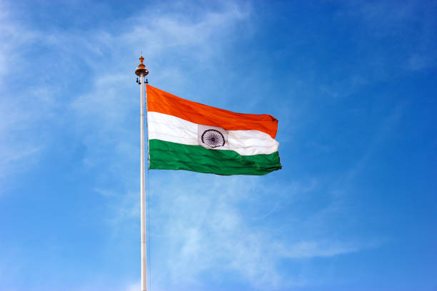 The Indian Flag flying high on top of a pole