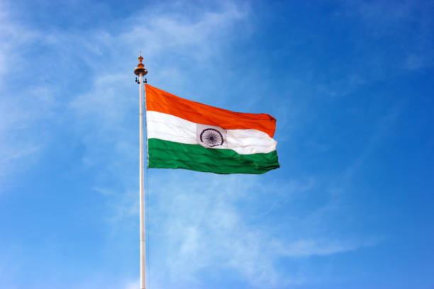 The Indian Flag flying high on top of a pole stock photo
