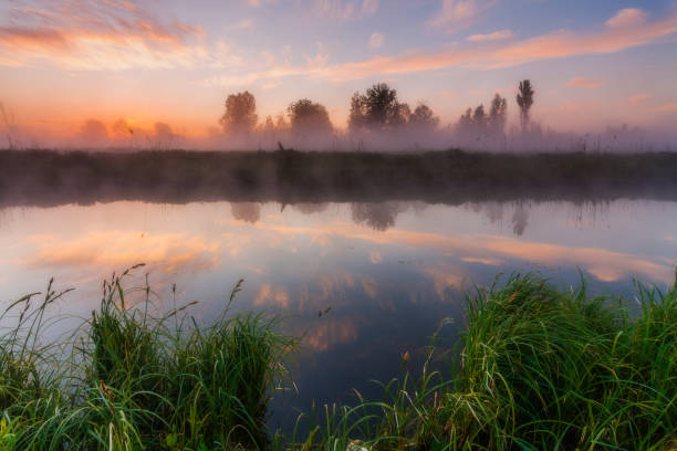 istock Reflection of a beautiful dawn sky in a river 940940722