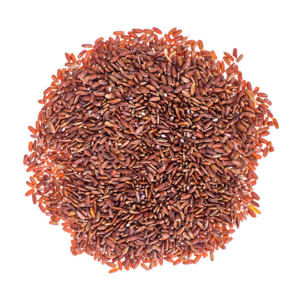 istock Scattering of red rice on white background closeup 940942202