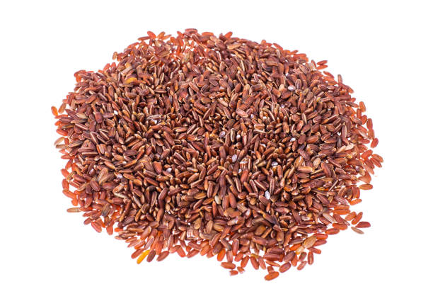 istock Scattering of red rice on white background closeup 940942218