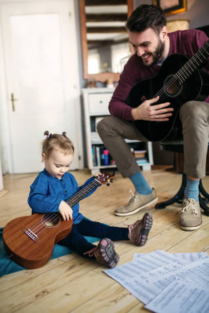 istock Daughter and father playing guitars 940942420