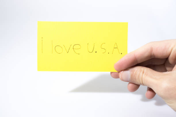 istock I love U.S.A. handwrite with a hand on a yellow paper composition 940945538