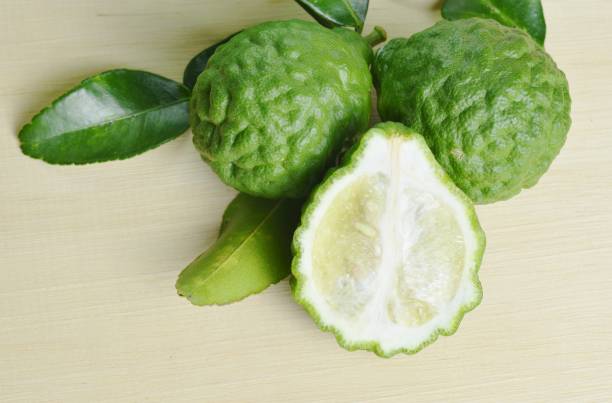 istock Bergamot fruit with leaf isolated on wooden board 940949408