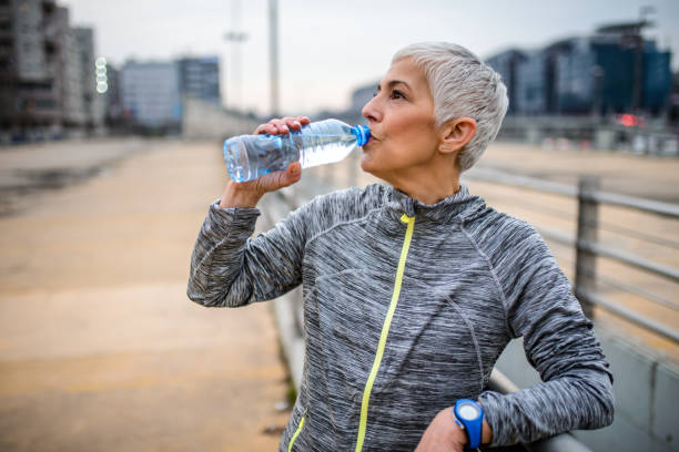 istock Mature woman drinking water. 940954862