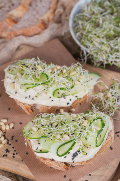 istock Healthy vegetarian bruschettas with bread, micro greens, hummus, cucumbers and pine nuts 940960726