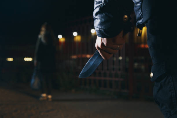 istock crime concepts robbery concepts a robber aimed his sharp knife at a woman to rob her valuable things in bag 940961952