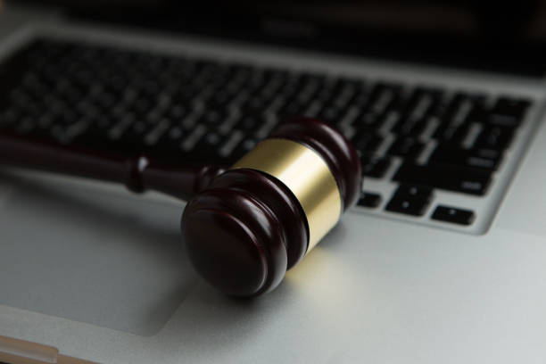 istock cyber law or crime internet concept. judges gavel on keyboard laptop computer. 940962798