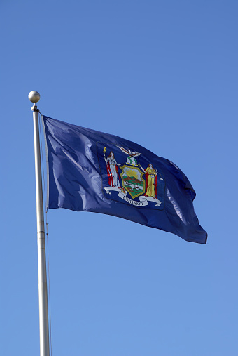 New York State Flag fully extended by the breeze.