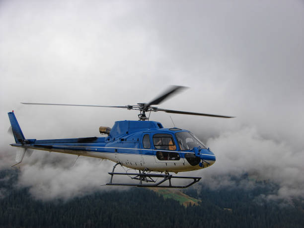 istock Blue helicopter flying in fog 940967972