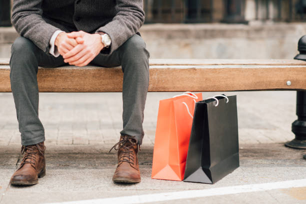 istock Happy man returning from a shopping mall with shopping bags 940968642