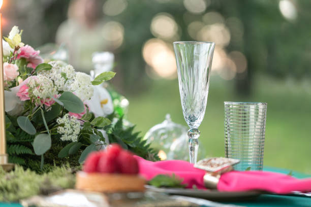 istock table setting. Wedding decor in the magic forest for a loving couple. Pink and green colors. Raspberry dessert. 940968888