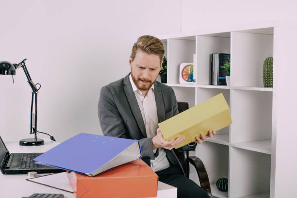 istock Serious business man handling files 940971736