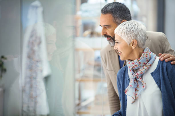 istock Mid aged couple in a shopping mall. 940975808