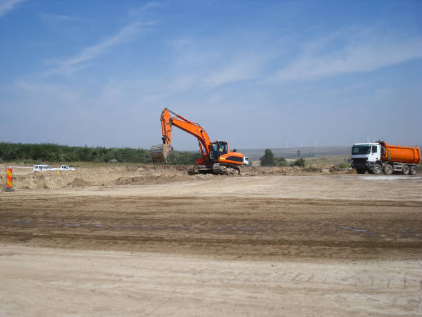 istock Excavator and truck 940980068
