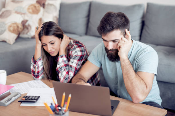 istock Worried young couple checking their bills 940980238