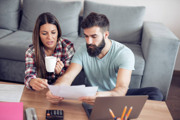 istock Worried young couple checking their bills 940980248