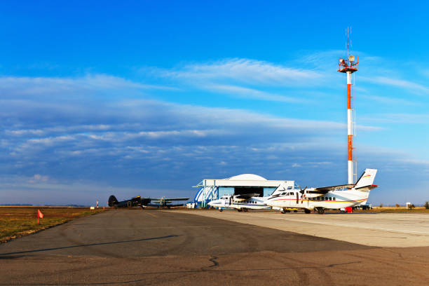 istock Light private planes parked on the airfield, private airfield with hangar and communications tower, early morning 940982768