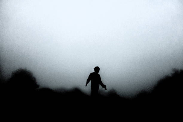 istock silhouette man carrying guns on both sides 940995724