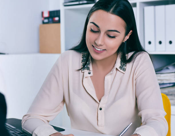 istock Smiling businesswoman speaking with costumer in office. 940995736