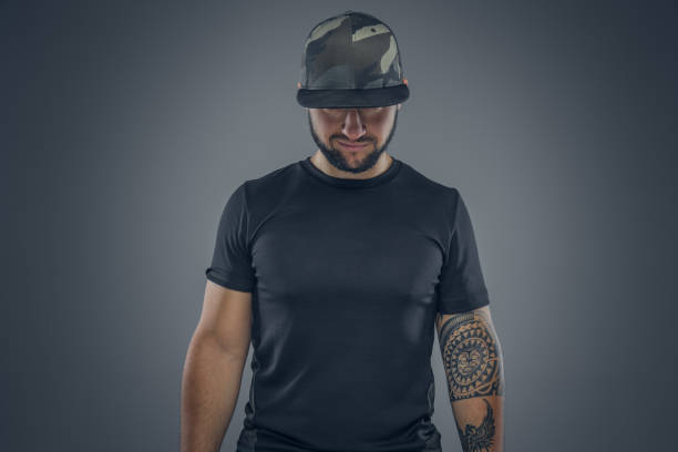 istock Bearded male in a baseball cap looking. 940995914