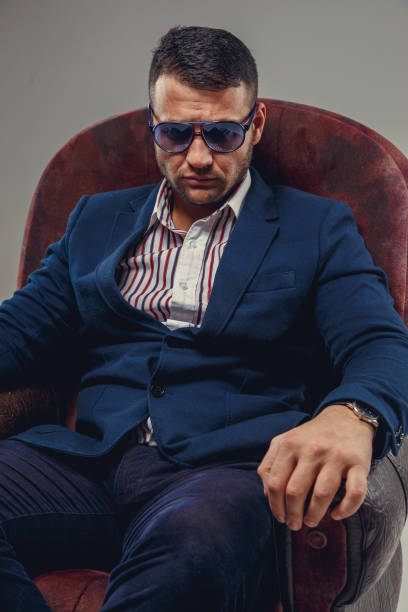 istock Serious bearded man in a suit and sunglasses. 940999844