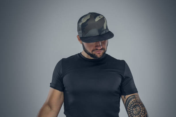 istock Bearded male in a baseball cap looking. 941001130