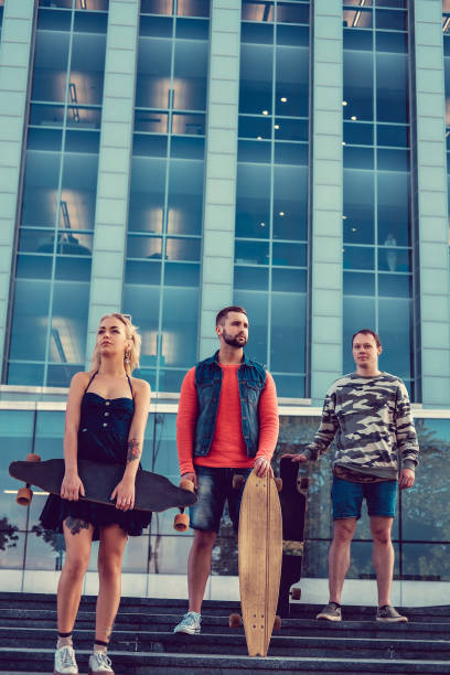istock Casual longboarders posing in a town. 941004458