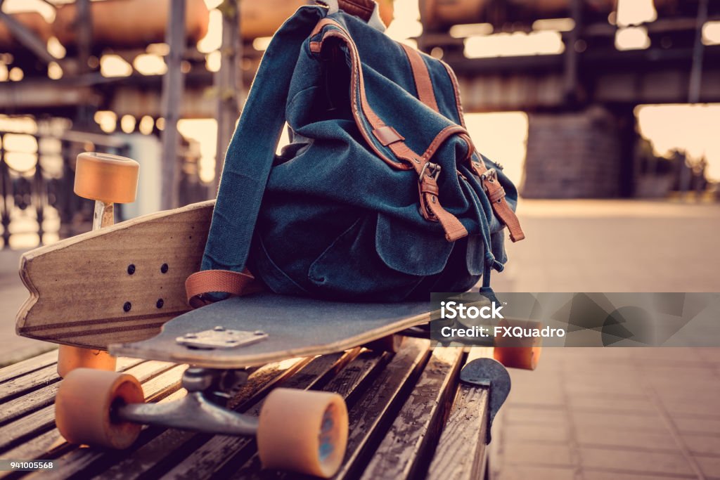 Longboard with backpack on it. Longboard Skating Stock Photo