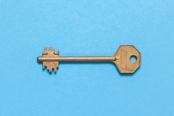 istock Old gold or copper keys on a blue background. 941009594