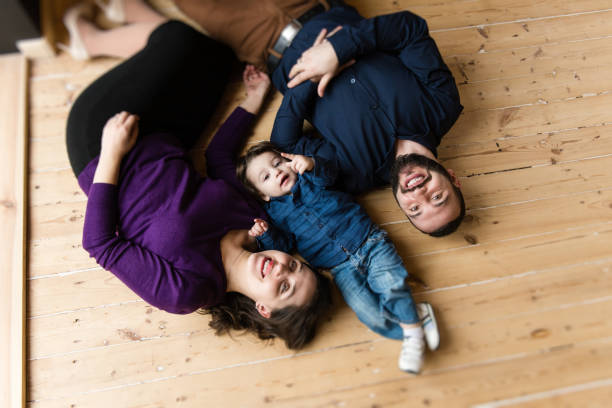 istock Happy family lay at floor 941009608