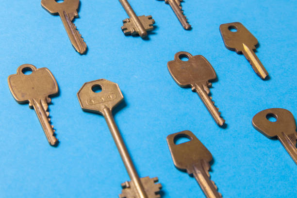 istock Old gold or copper keys on a blue background. 941009650