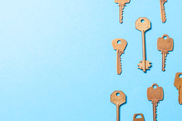 istock Old gold or copper keys on a blue background. Copy space for text 941011794