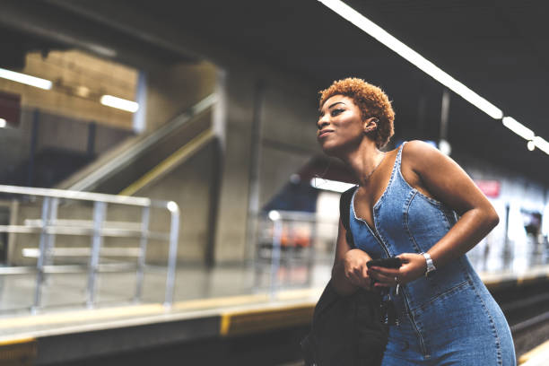 istock Girl waiting the train at station 941012026