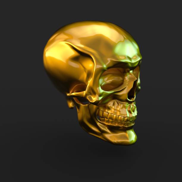 istock Golden glossy skull with light reflections isolated on black background 941013272