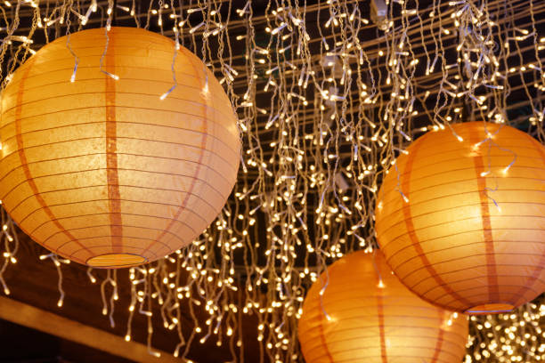 istock Beautiful paper lanterns among white lights 941013342