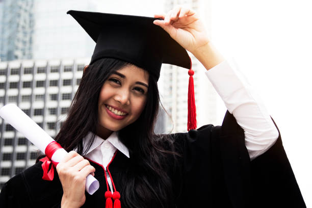 istock Beautiful girl students are happy after graduation. 941014372
