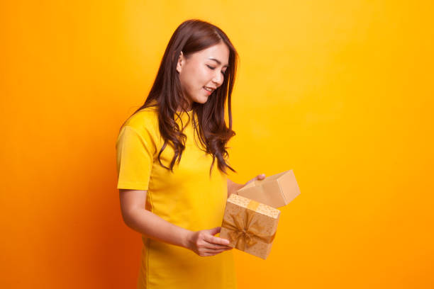 istock Young Asian woman open a gift box. 941014530