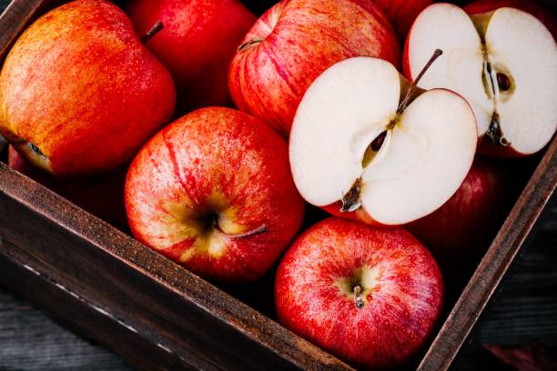 istock red ripe apples in a box on a wooden background 941017746