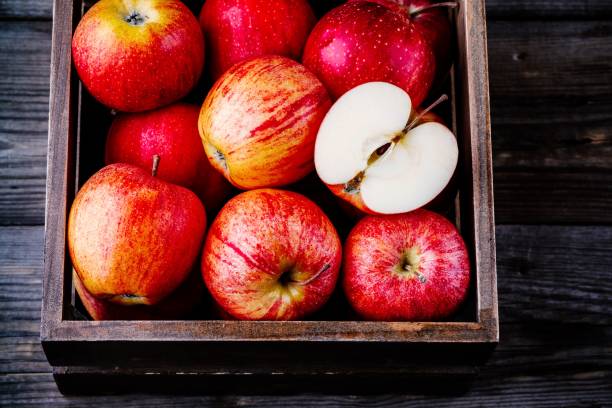 istock red ripe apples in a box on a wooden background 941017764