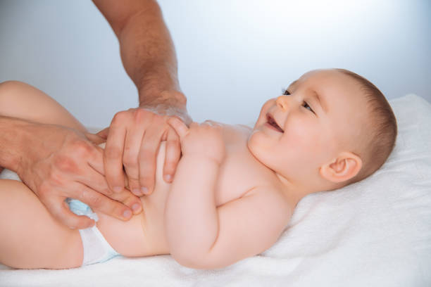 istock Doctor massaging a cute baby 941020792