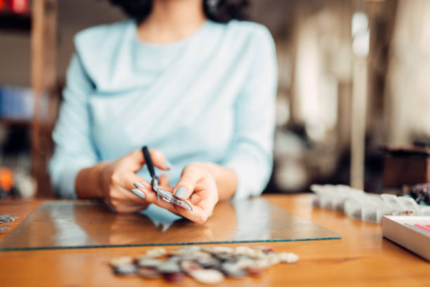 istock Female hands with scissors, handmade jewelry 941021298