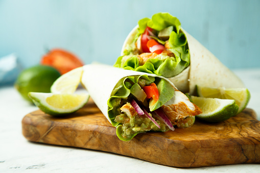 Chicken wraps with green salad and vegetables