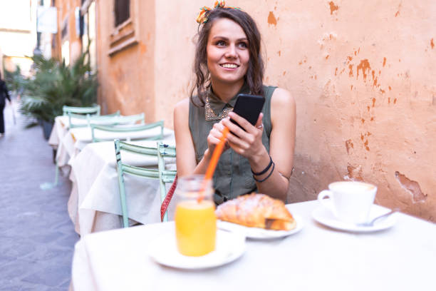 istock Young beautiful woman having breakfast in Rome 941025206